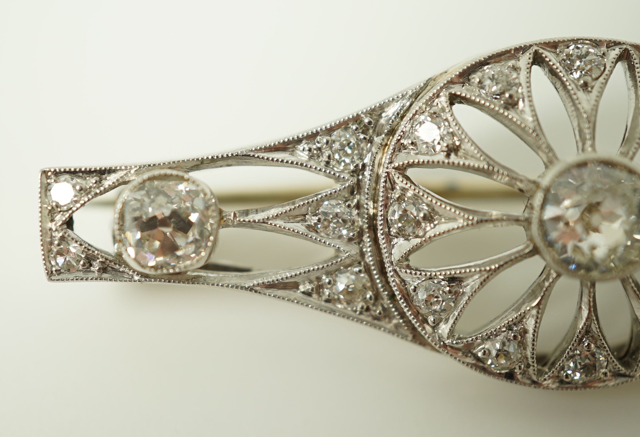 A 1920's pierced white gold and diamond cluster set brooch